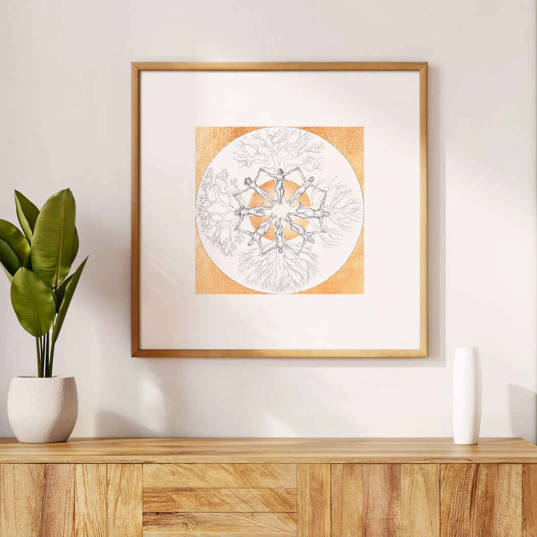 Framed artwork on a wall above a wooden cabinet with a plant and vase.