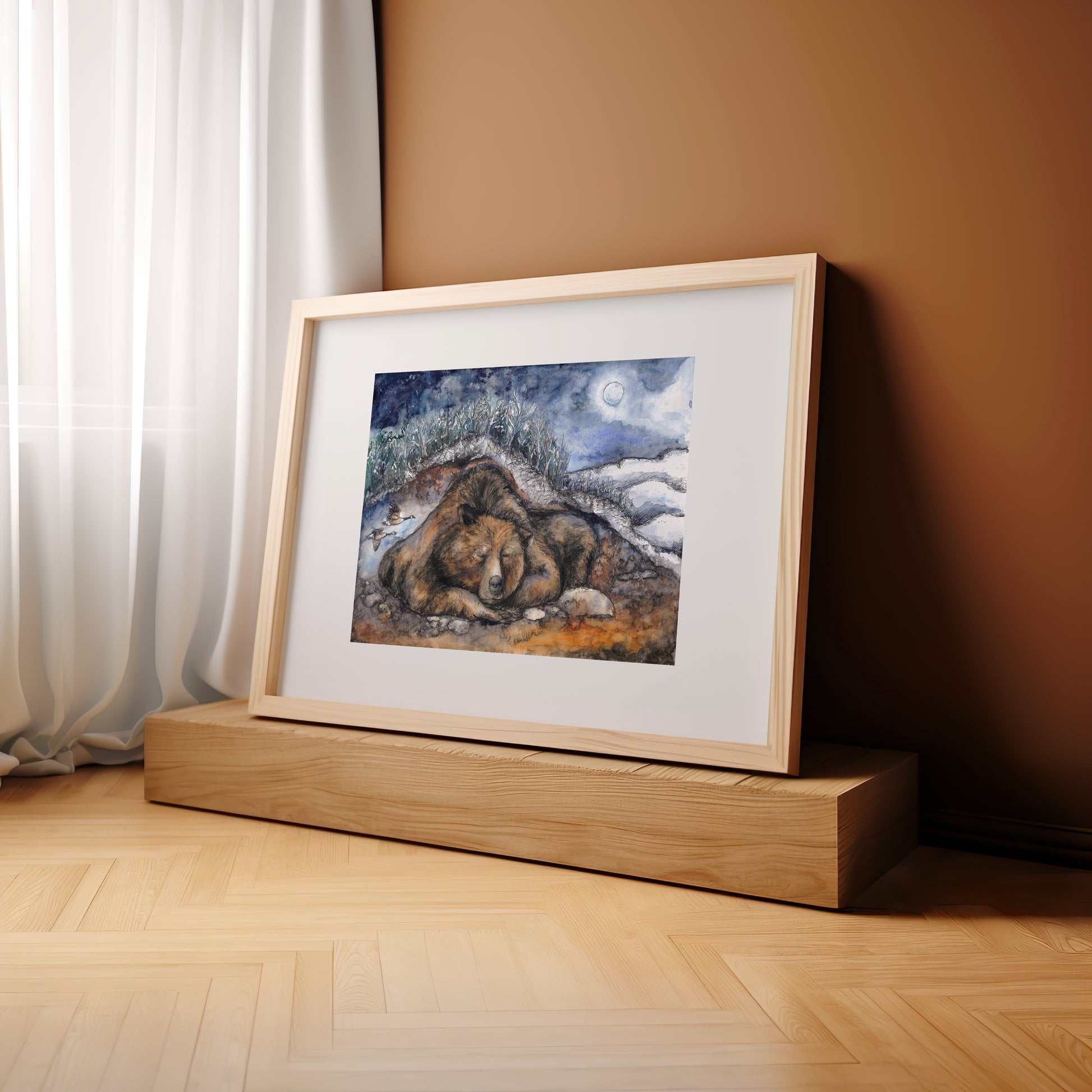 Framed artwork of a bear on a wooden platform against a beige wall.