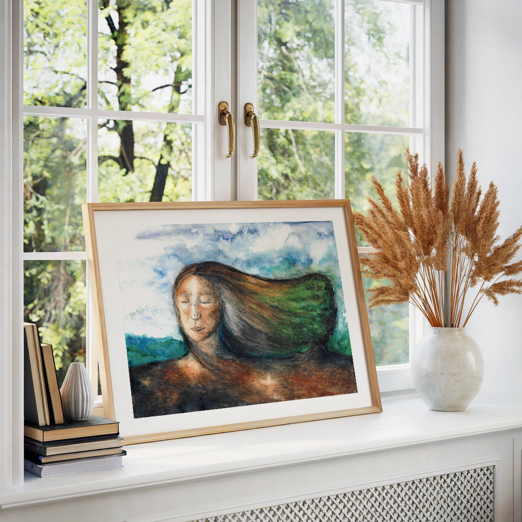 Framed artwork of a woman with long hair connecting to a tree, on a windowsill with natural light